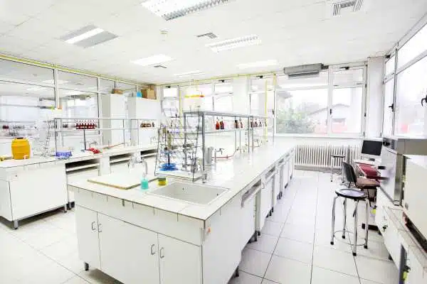 Laboratory bench with glassware and reagent storage where sample conditions are logged